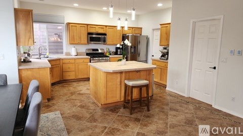 A kitchen with wooden cabinets and a central island.