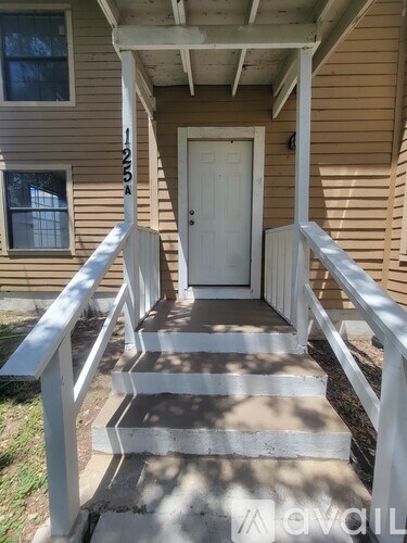 A white door is on the right side of the stairs.