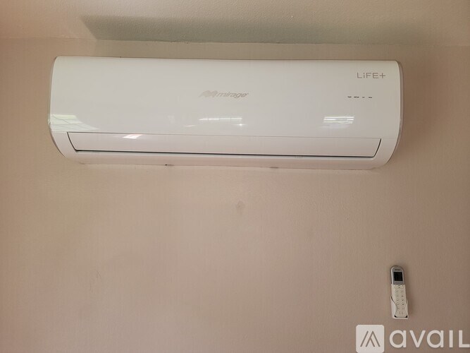 A white LIFE+ air conditioner is mounted on a wall.