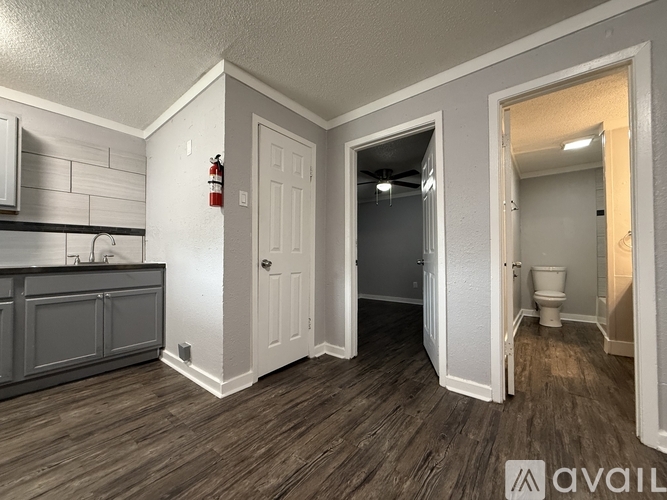 A kitchen with a refrigerator, oven, and cabinets.