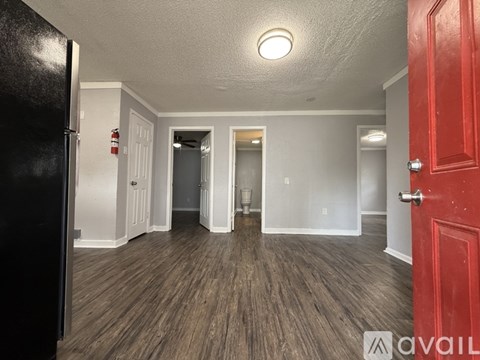 A room with a ceiling fan and a window.