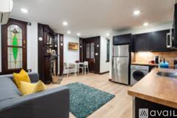 A modern kitchen with dark wood cabinets and a stainless steel refrigerator.