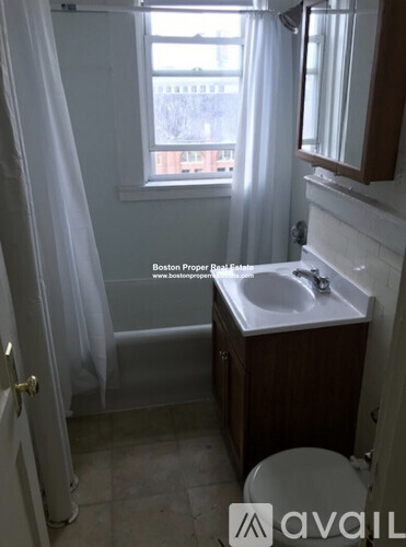 A bathroom with a toilet, sink, and shower.