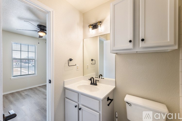 A bathroom with a white sink and toilet.