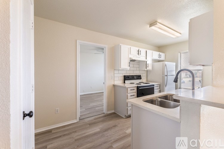 A kitchen with white cabinets and a sink.