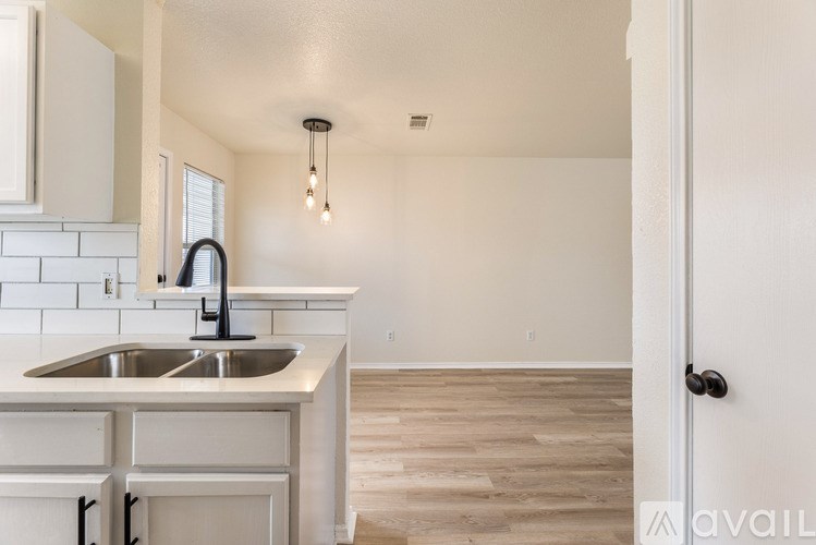 A kitchen with a sink and a door.