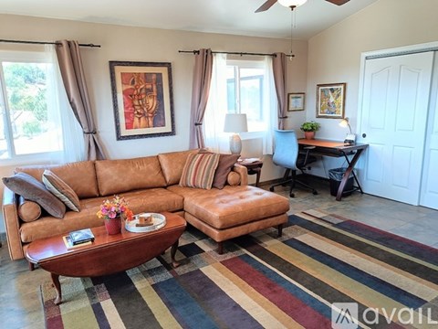 A living room with a brown sofa and a coffee table.