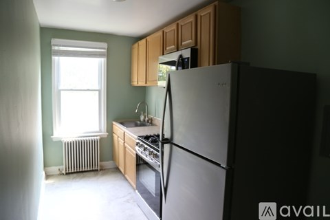 A kitchen with a refrigerator, stove, and sink.