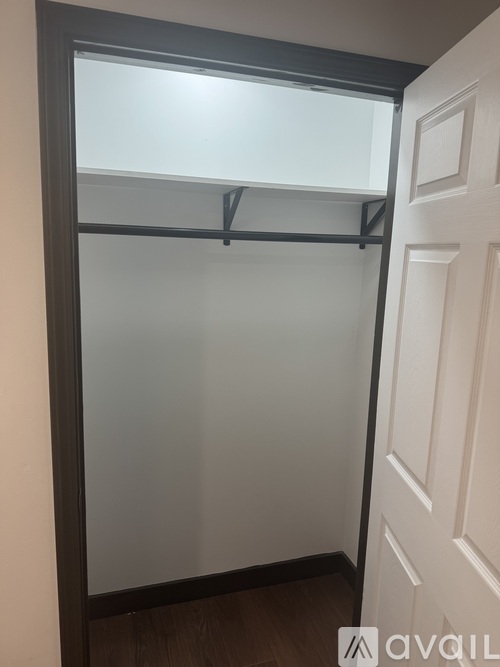 A white door with a glass window is open.