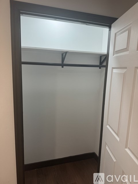 A white door with a glass window is open.