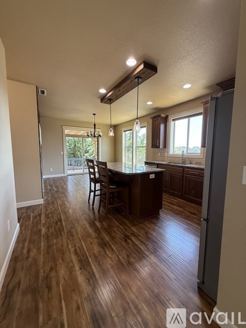 A kitchen with wooden floors and a dining table.