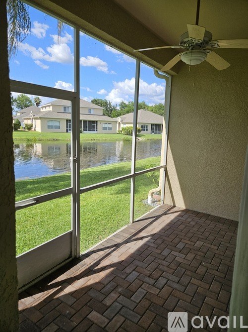 A patio with a sliding glass door opens to a flooded backyard.