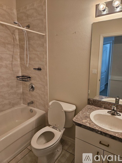 A bathroom with a toilet, sink, and bathtub.