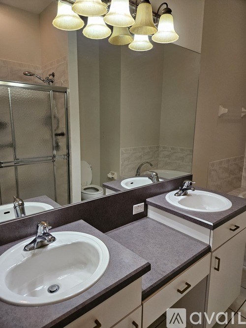 A bathroom with two sinks and a mirror.