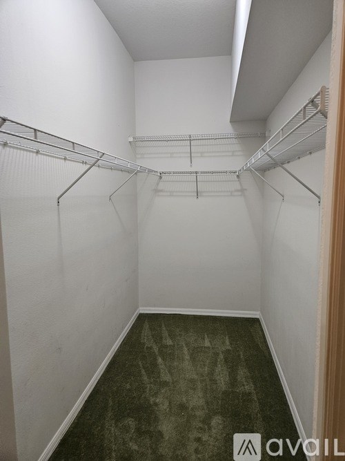 A white hallway with a green floor and a white wall.
