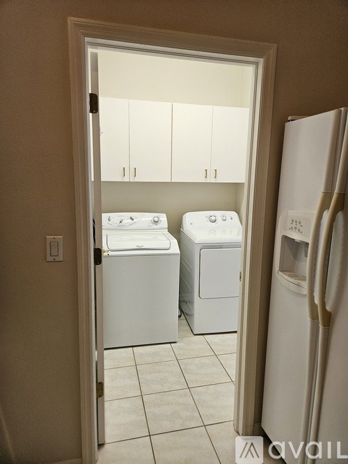 A white washing machine and dryer in a laundry room.