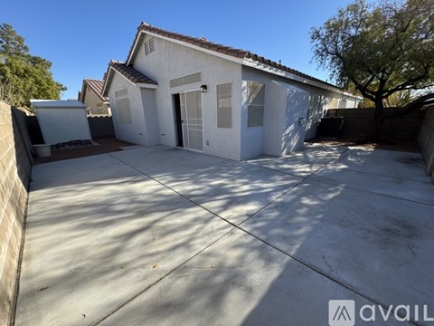 A house with a white exterior and a brown roof is available for rent.