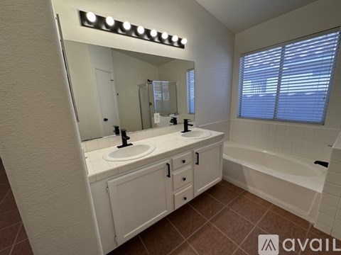 A bathroom with a white sink and a bathtub.