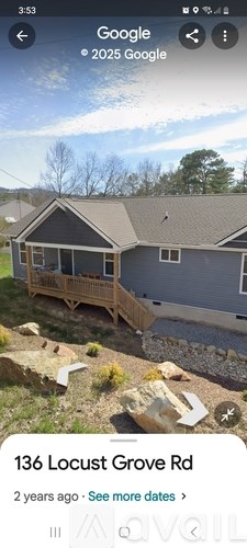 A house with a grey roof and a wooden deck.