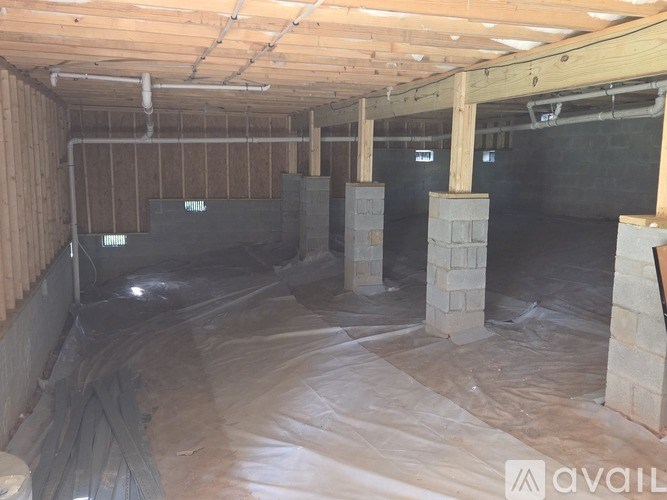 A Google Maps image of a residential area with a house, cars, and a dirt path.