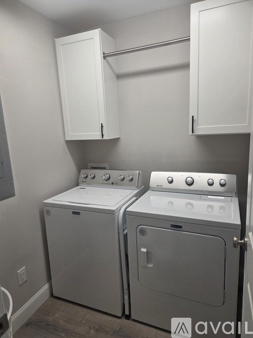 A modern bathroom with a large mirror and a sink.
