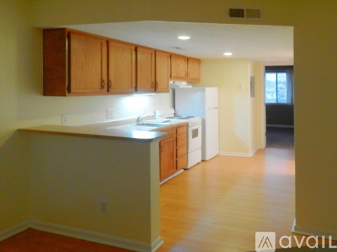 A kitchen with wooden cabinets and a white refrigerator.