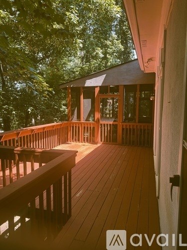 A wooden deck with a railing and a door.