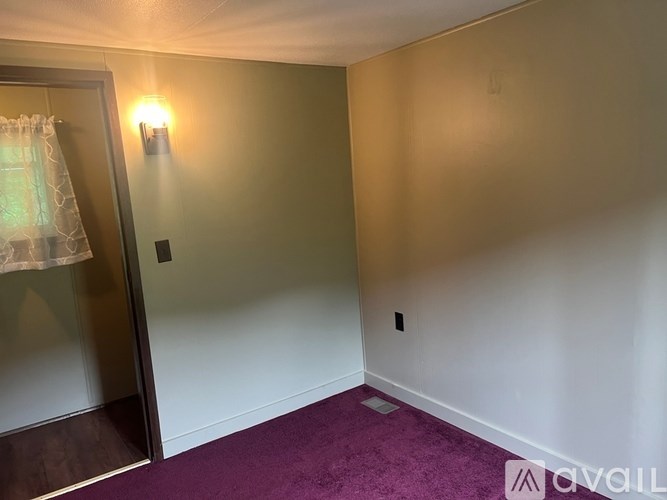 A kitchen with wooden cabinets and a white stove top oven.