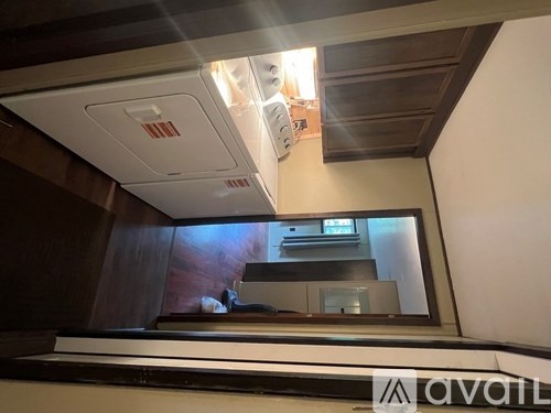 A modern kitchen with a stainless steel refrigerator and a wooden countertop.