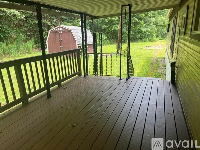 A small kitchen with wooden cabinets and a microwave.