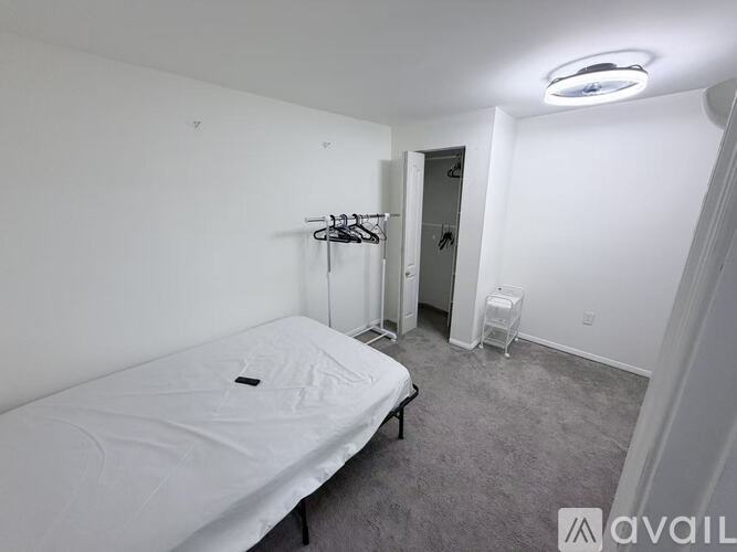 A mattress is available for rent in a room with white walls.