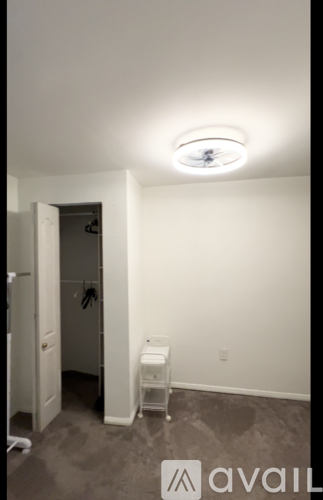 A shower area with a glass door and a white shower seat.