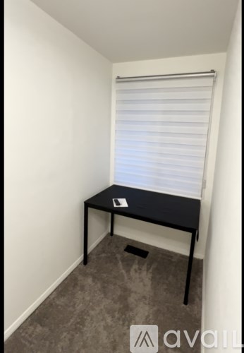 A bathroom with a toilet, sink, and a shower stool.