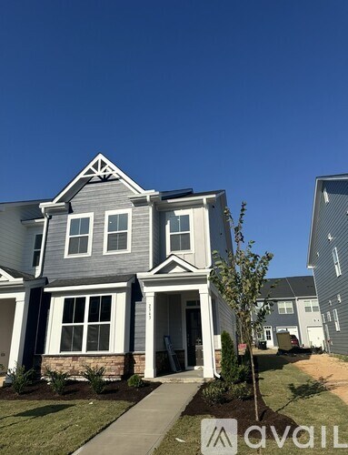 A house with a grey front and a white door.