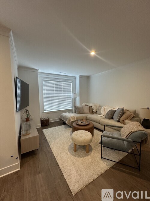 A living room with a couch, chair, and television.