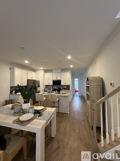 A modern kitchen with a dining table set for two.