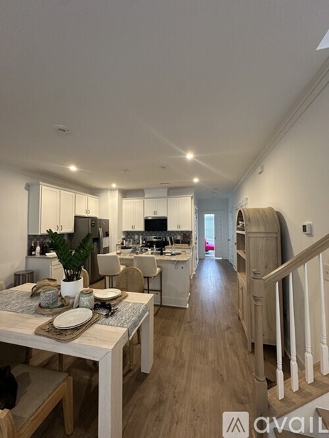 A modern kitchen with a dining table set for two.