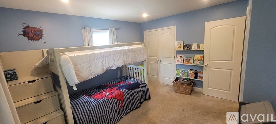 A bedroom with a bunk bed and a single bed.