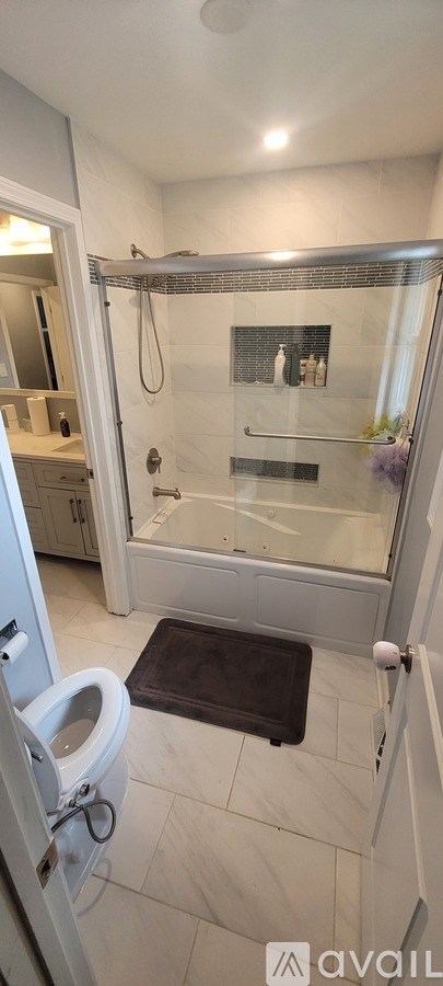 A bathroom with a toilet, sink, and shower.