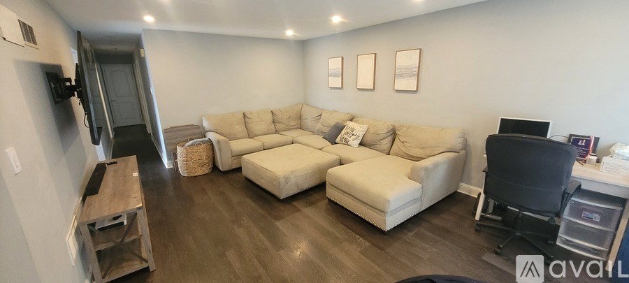A living room with a large couch and a television.