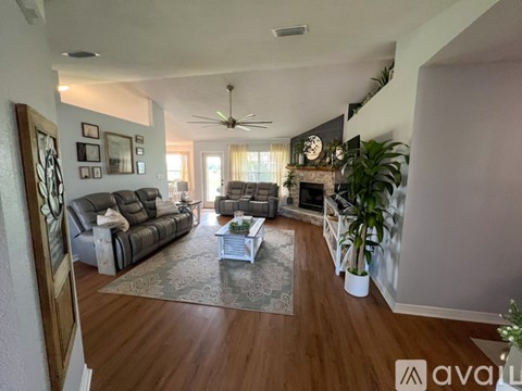 A living room with a grey sofa and a coffee table.