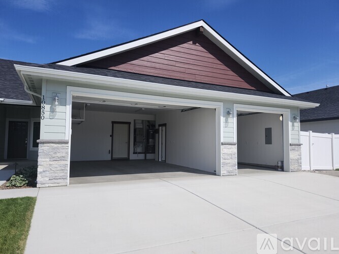 A two-car garage with a white exterior and a red roof.