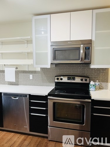 A kitchen with a stove top oven and microwave above it.