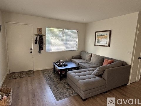 A living room with a grey couch and a coffee table.