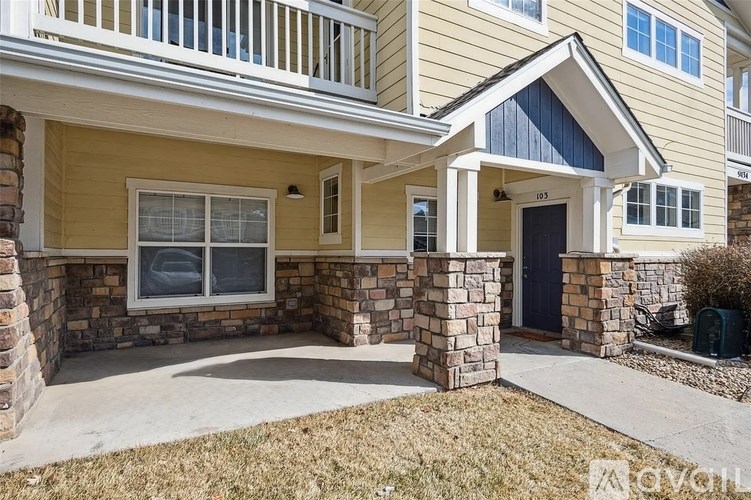 A two-story house with a front porch and a garage door.