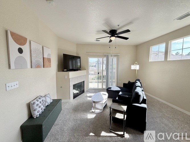 A living room with a fireplace, a couch, and a television.