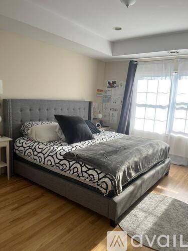 A bedroom with a large bed and a window.