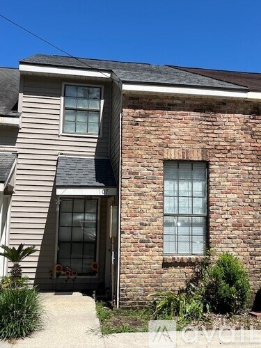 A house with a brick wall and a window.