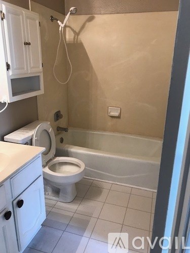 A bathroom with a toilet, sink, and bathtub.