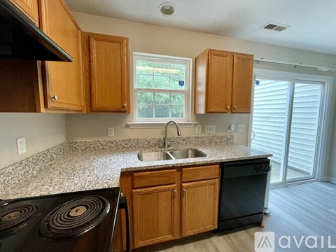 A kitchen with wooden cabinets and granite countertops.
